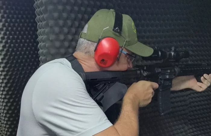 A guy looking through the scope of a gun